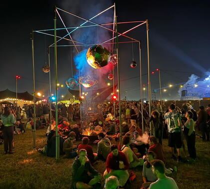 Sidcot School art project on display at Glastonbury Festival with crowds around it.