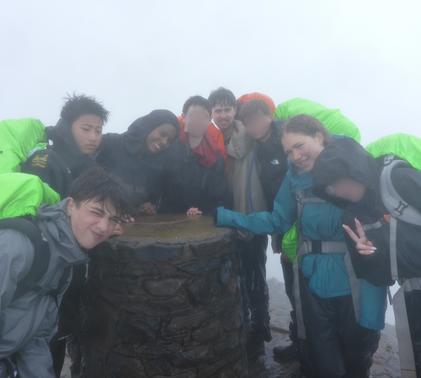 Gold DofE group smiling at the summit of Snowdon