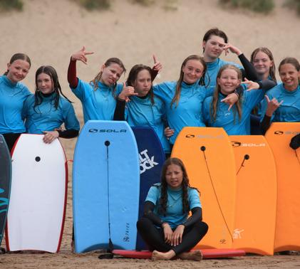 A group of Year 9 students, posing with their paddleboards